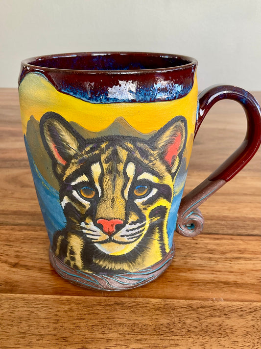 Clouded leopard and sunset mountain mug